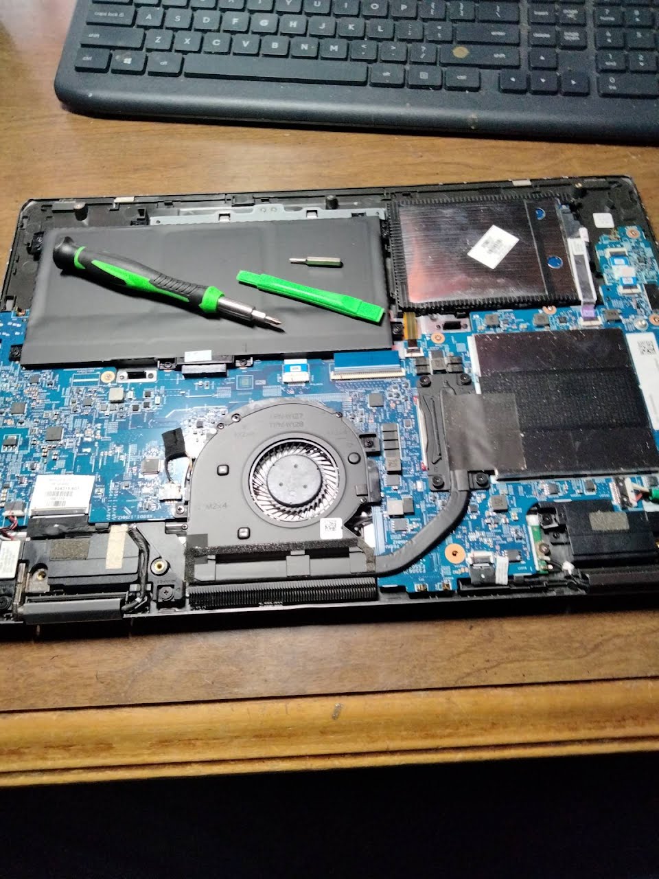 Laptop opened for repair on a workbench